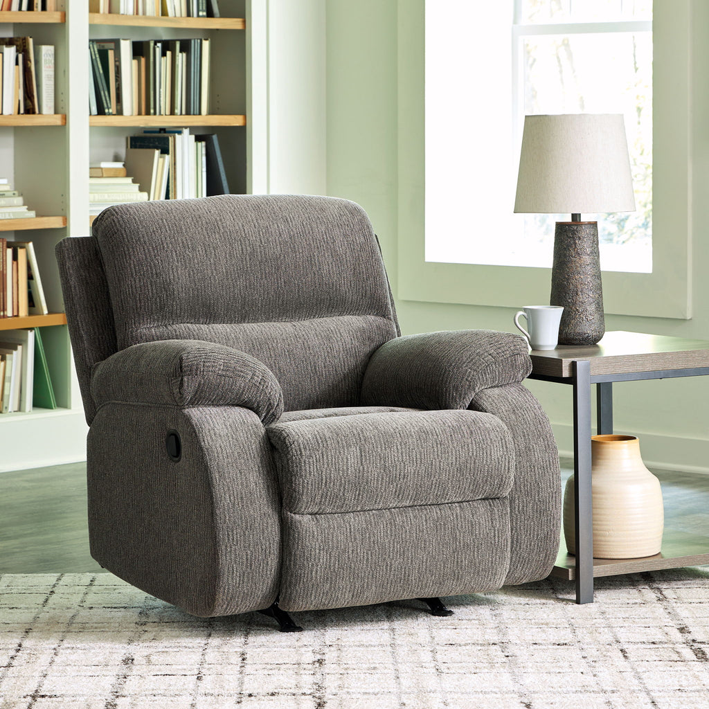 Dark gray rocker recliner chair with cushioned back and padded armrests