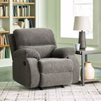 Dark gray rocker recliner chair with cushioned back and padded armrests