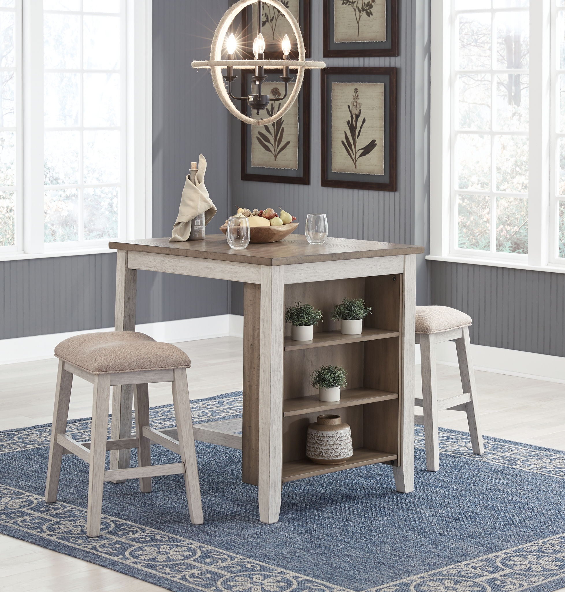 Rectangular counter table with open shelving and two beige upholstered stools