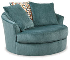 Teal upholstered oversized swivel accent chair with two matching back cushions