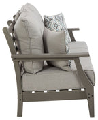Gray outdoor sofa chair-style seat with armrest, back cushions, and patterned throw pillow