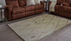 Beige and brown geometric area rug with repeating X and diamond motifs.