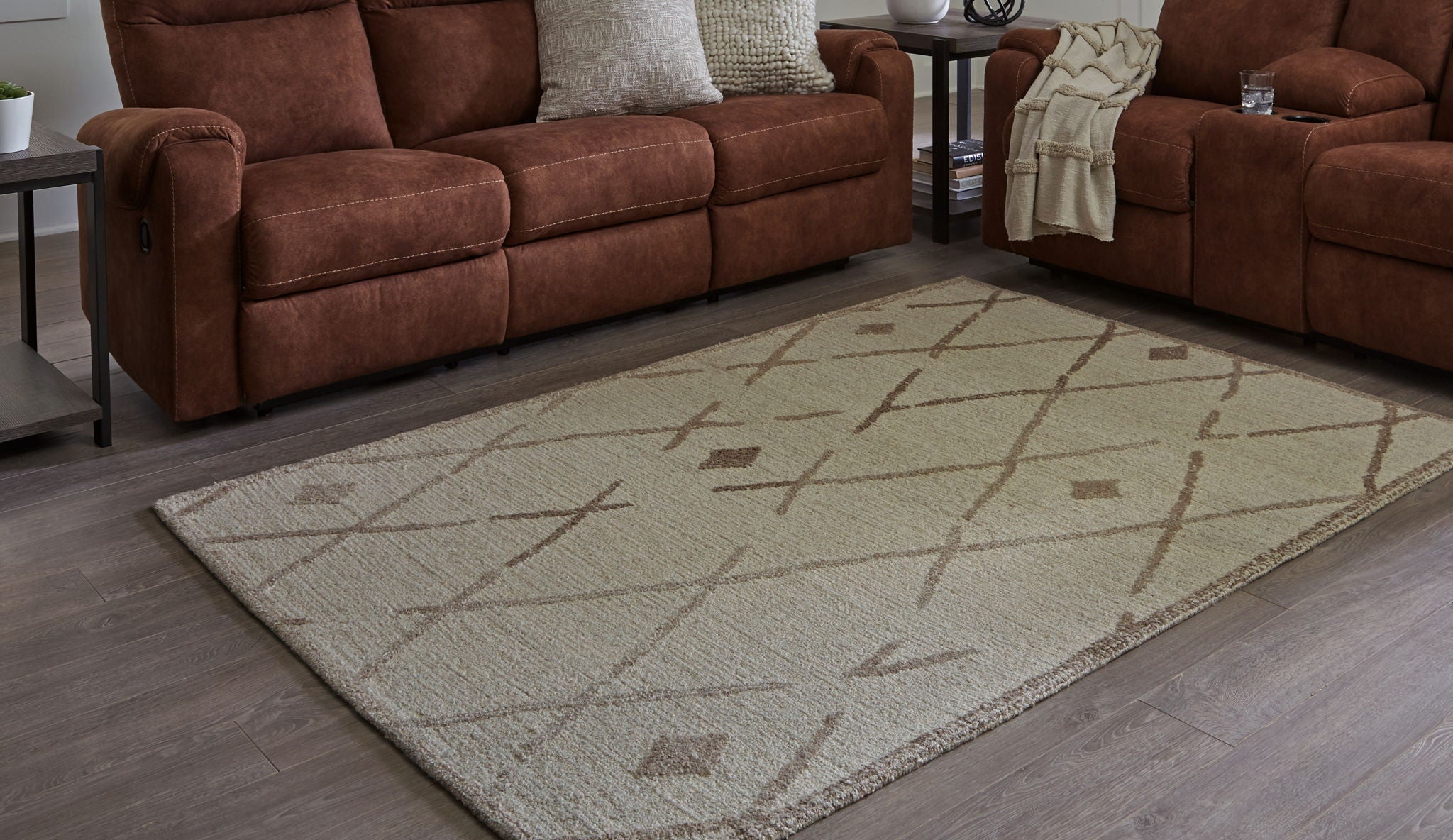 Beige and brown geometric area rug with repeating X and diamond motifs.