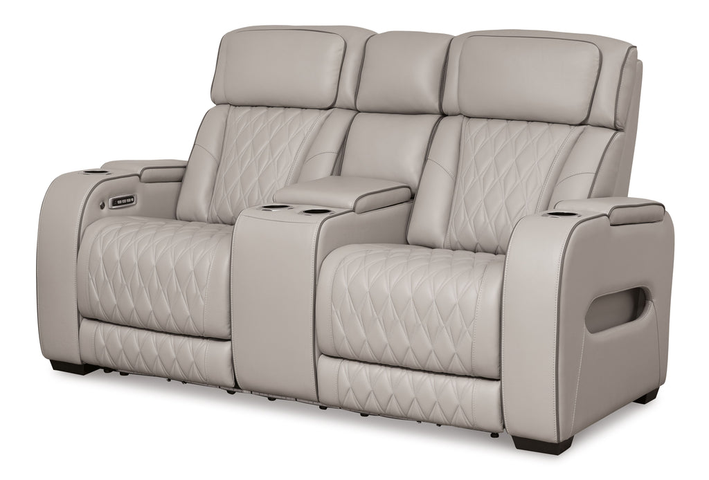 Gray power reclining loveseat with console, quilted seats, and adjustable padded headrests