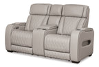 Gray power reclining loveseat with console, quilted seats, and adjustable padded headrests