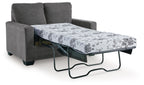 Dark gray sofa bed with pulled-out mattress and floral patterned cover