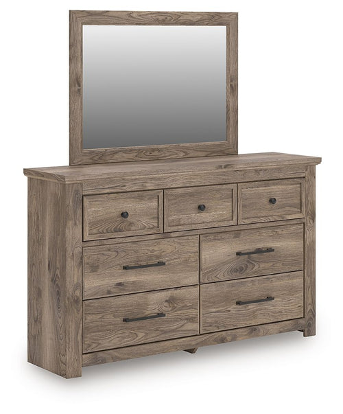 Light brown dresser with framed mirror and six drawers