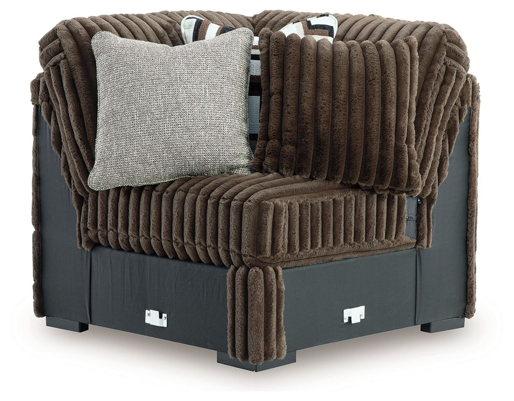 Chocolate brown sectional wedge with corduroy-textured cushions and square accent pillow