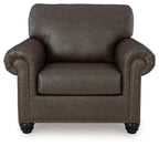 Roxmere chair front view in dark umber fabric with studded trim and turned legs