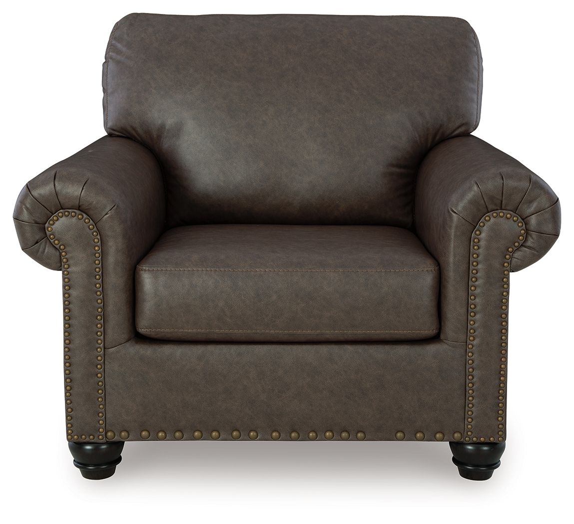 Roxmere chair front view in dark umber fabric with studded trim and turned legs