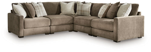 Coffee-brown L-shaped sectional sofa with chaise ottoman-style end and decorative pillows