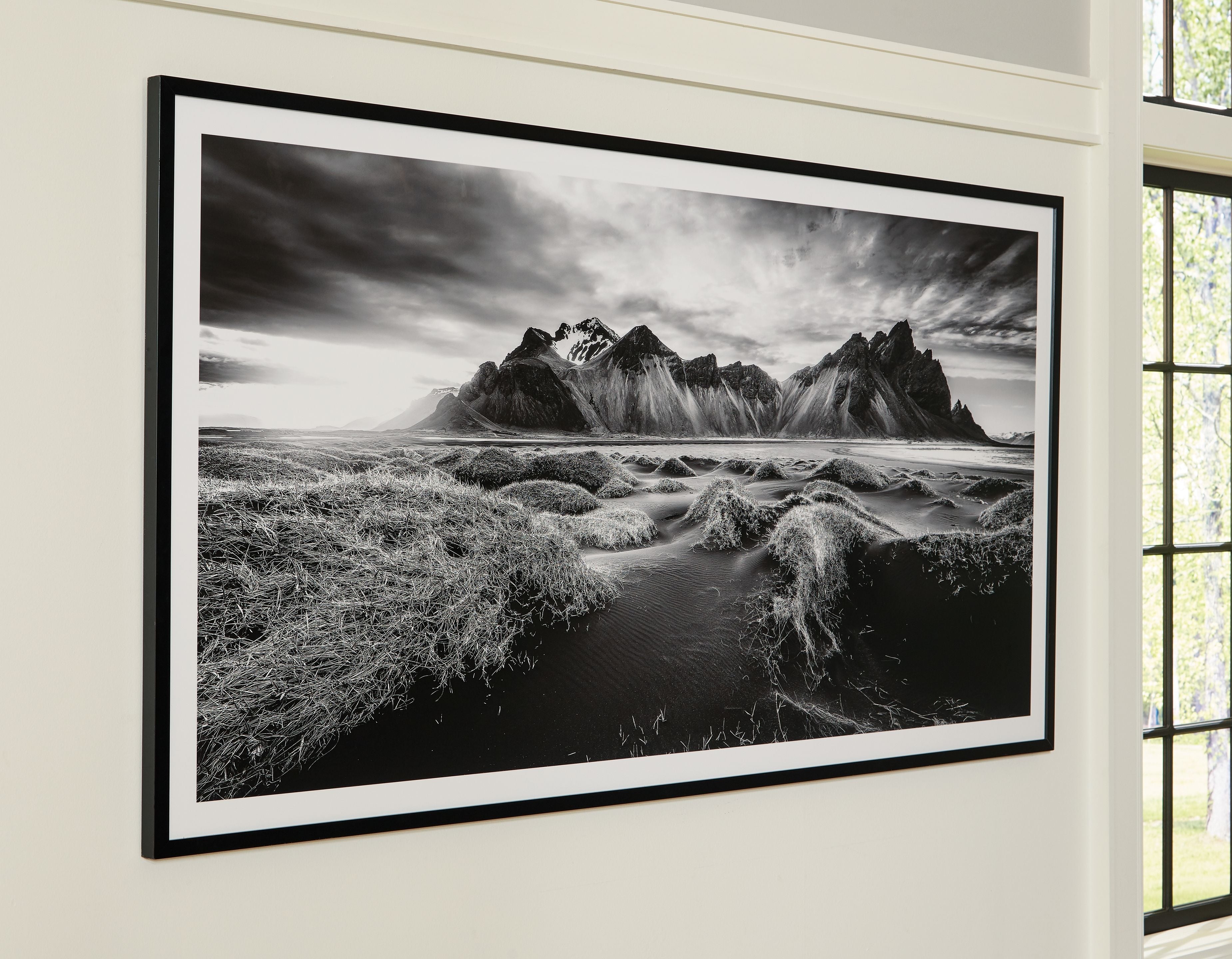 Black frame wall art with black-and-white mountain landscape, wide horizon