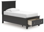 Black panel bed with a single storage drawer beneath the foot end.
