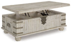 Whitewashed gray lift-top cocktail table with open storage compartment and metal hinges