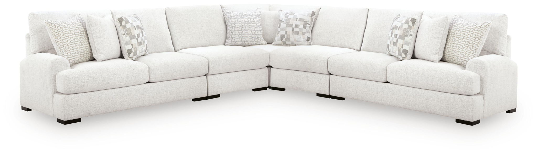 Off-white corner sectional sofa with chaise ends and patterned pillows, dark feet