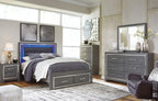 Gray panel bed with dark upholstered headboard and two storage drawers, bedding included
