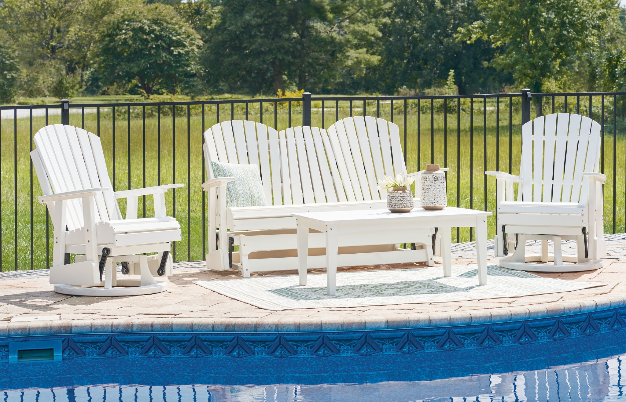 Outdoor set with white slat-back loveseat, two chairs, and square coffee table