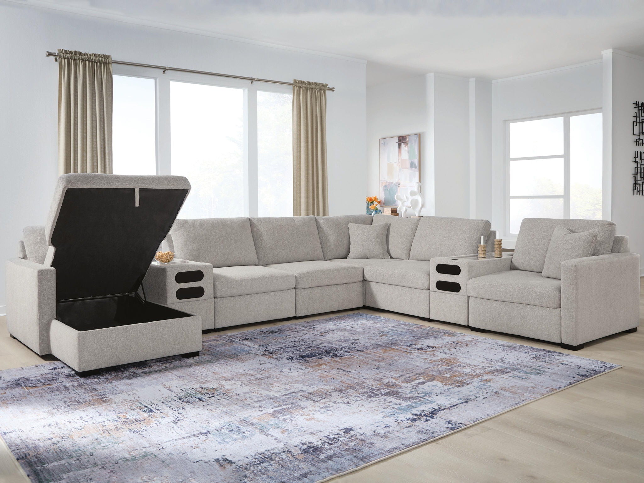 Gray sectional sofa with chaise seating and dark upholstered side panel, open storage area
