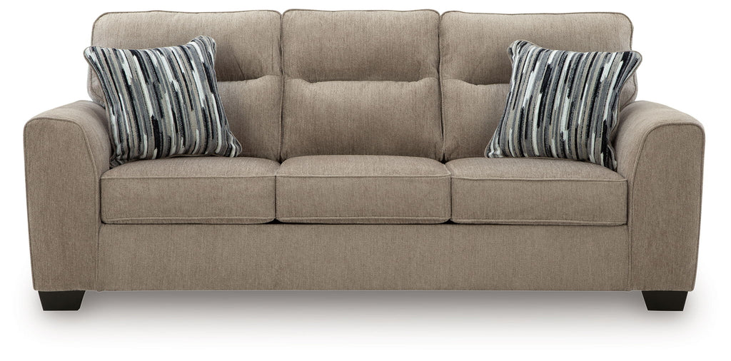 Light brown 3-seat sofa with three cushions and two striped throw pillows