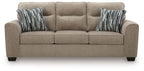 Light brown 3-seat sofa with three cushions and two striped throw pillows