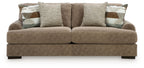 Taupe fabric sofa with three seat cushions and two back throw pillows