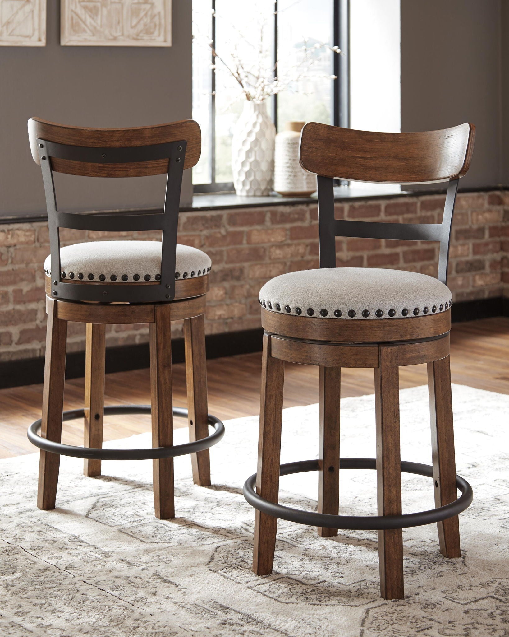 Dark brown full-back swivel bar stool with round padded seat and nailhead trim