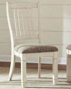 White dining side chair with vertical slat back and beige upholstered seat