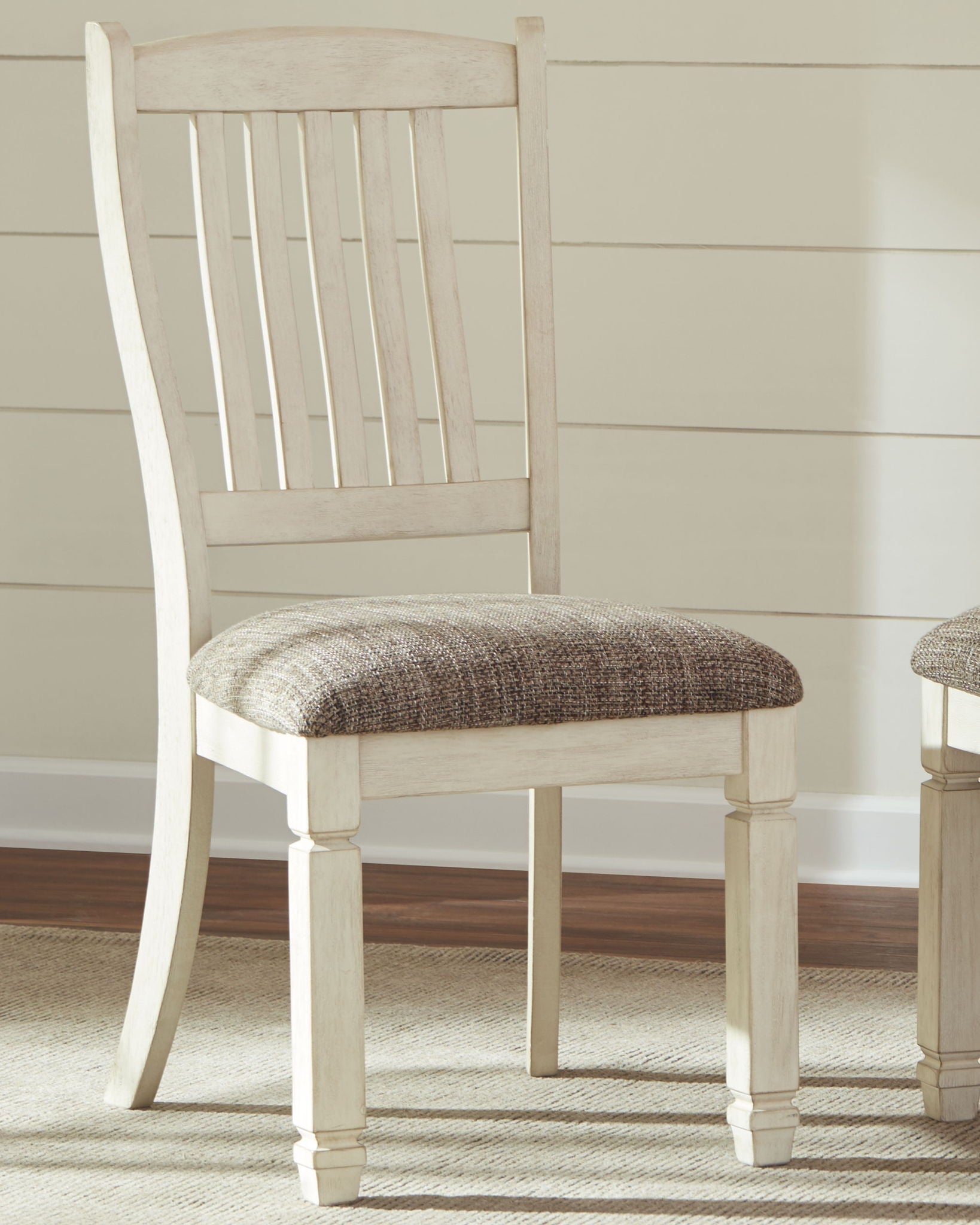 White dining side chair with vertical slat back and beige upholstered seat