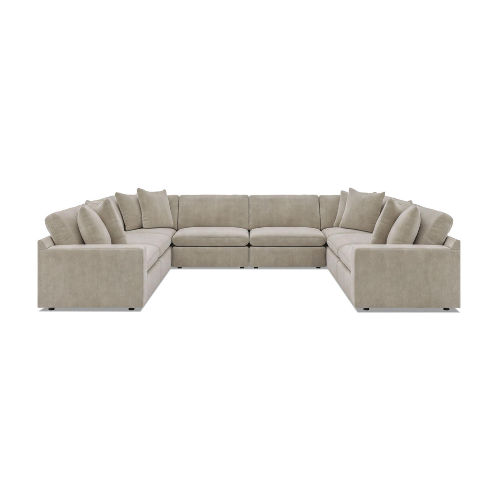 Beige 8-piece sectional sofa with tufted back cushions and rounded arm sections