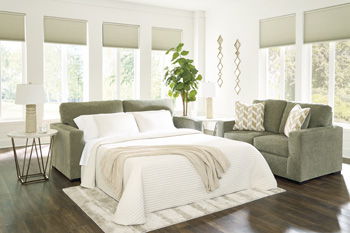 Bridgepoint sofa sleeper with bed extended, white striped blanket and two pillows