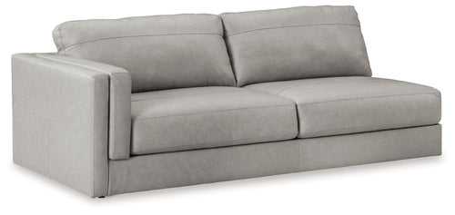 Light gray two-seat Laf sofa with boxy arms and tufted seat cushions