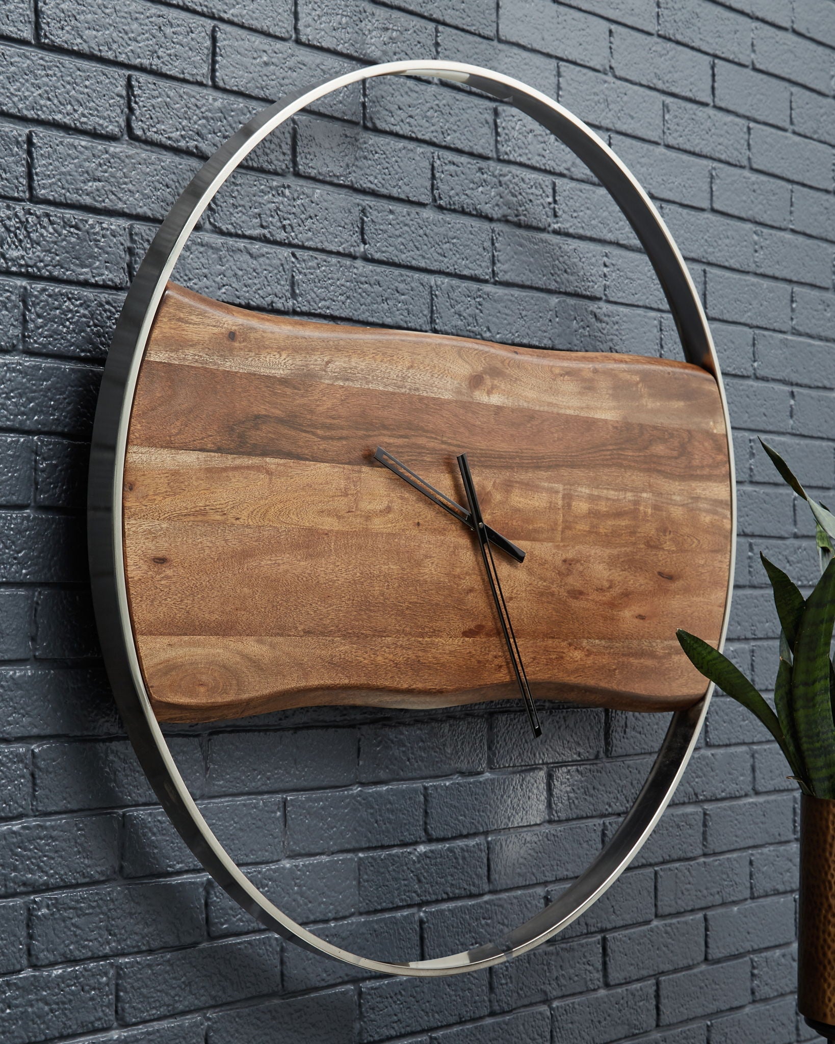 Brown wood-grain wall clock with oval silver bezel and black hands
