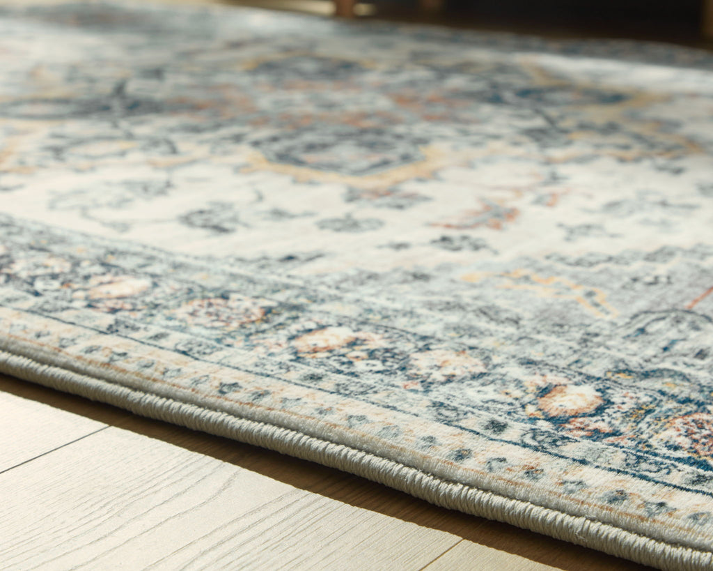 Wallney rug close-up of faded cream and blue patterned surface