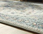 Wallney rug close-up of faded cream and blue patterned surface