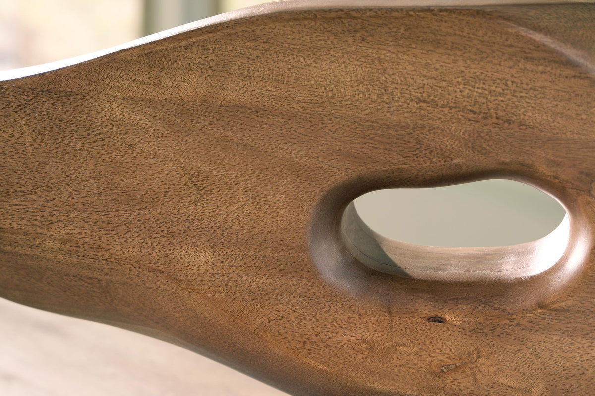 Light brown wooden sculpture surface with oval opening and brushed metal insert