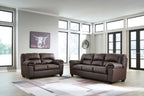 Upholstered living room sofa and recliner set in dark brown with tufted back cushions.