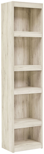 Whitewash wood bookcase with four open shelves and vertical side panels