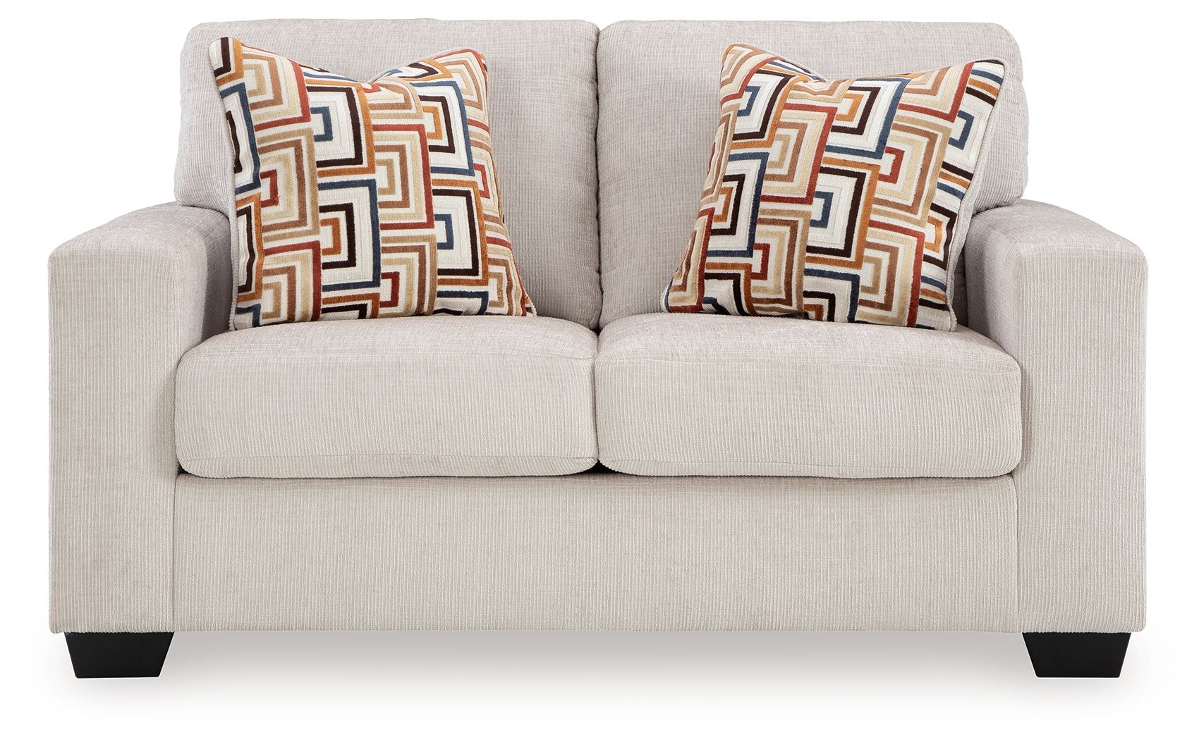 Light beige loveseat with two patterned throw pillows and low, squared arms.