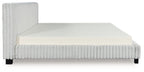 White upholstered platform bed with tall side panels and padded mattress base.