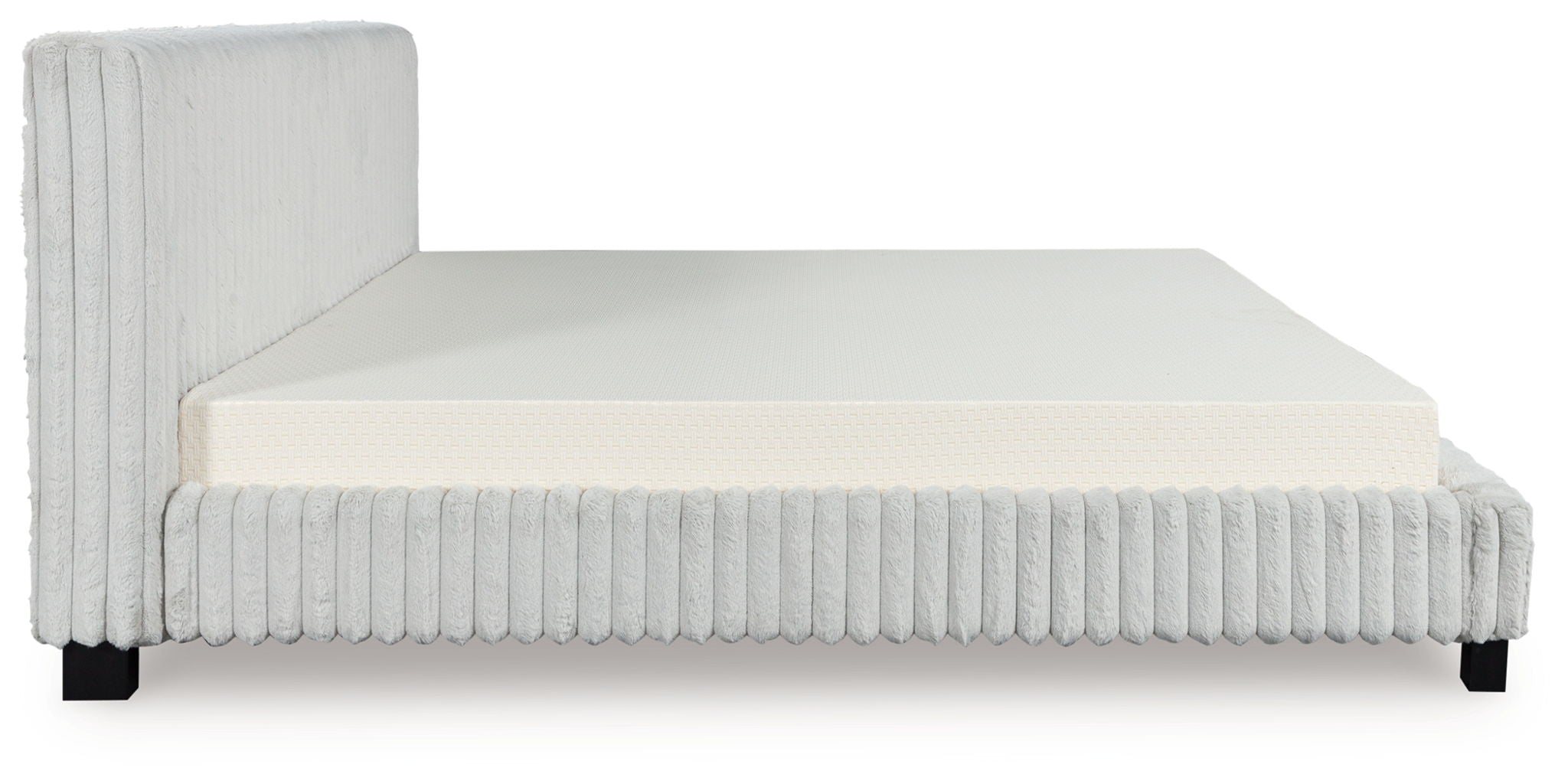 White upholstered platform bed with tall side panels and padded mattress base.