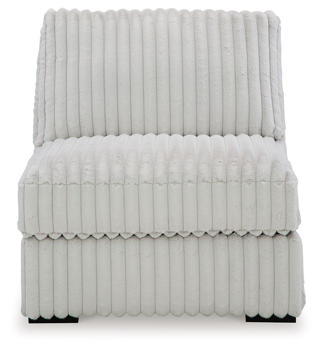 Light gray armless upholstered chair with high back and padded seat in channel quilting.