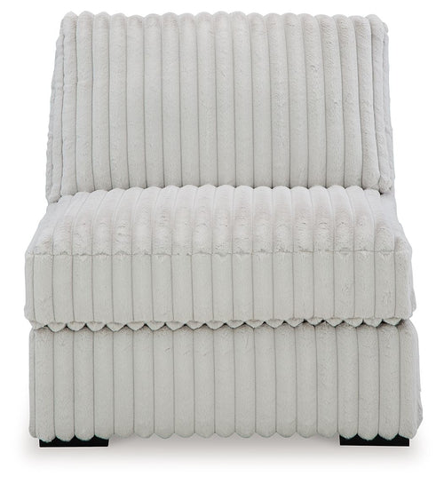 Light gray armless upholstered chair with high back and padded seat in channel quilting.