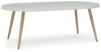 White oval dining table with tapered legs and smooth tabletop