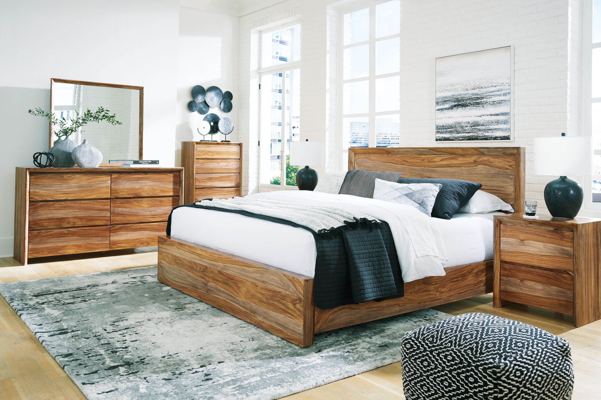 Wood platform bed with low drawer base, flanked by two matching dressers