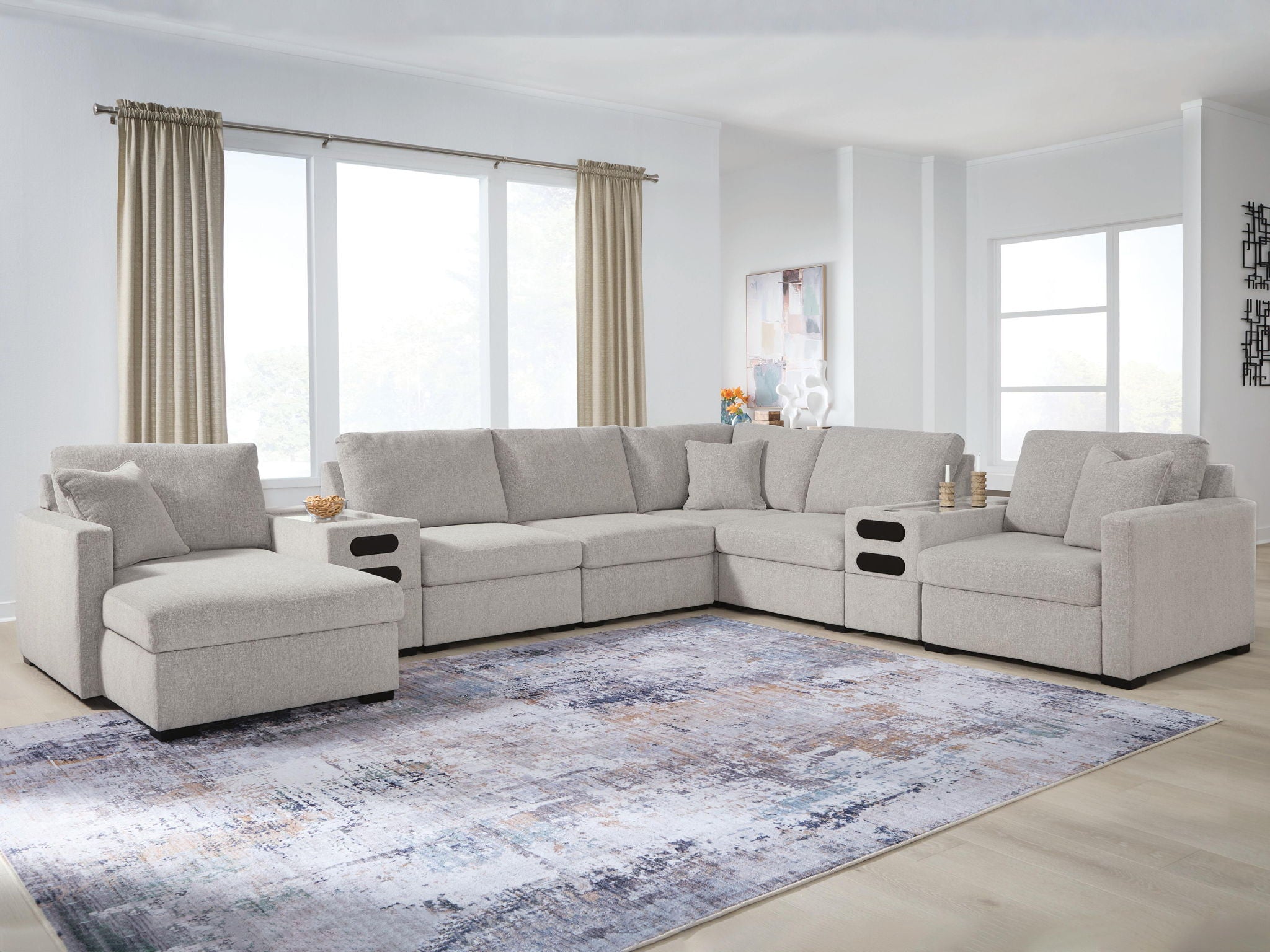 Gray sectional sofa with chaise seating and dark console panels at the side ends