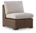 Armless chair with cushion in beige fabric and brown woven wicker base