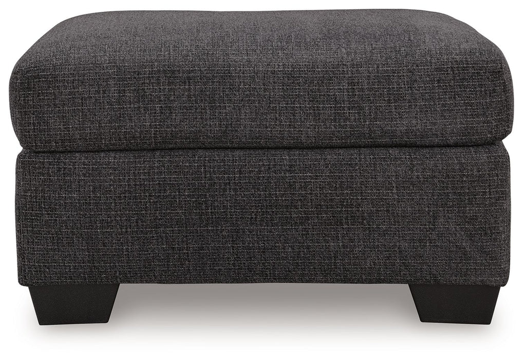 Charcoal gray fabric ottoman with cushioned top, straight sides, and black legs