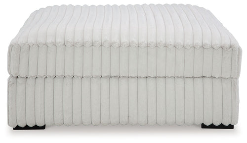Oversized accent ottoman, light gray ribbed fabric with skirted side panels