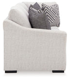 Stone beige sofa with corner wedge and dark patterned throw pillows