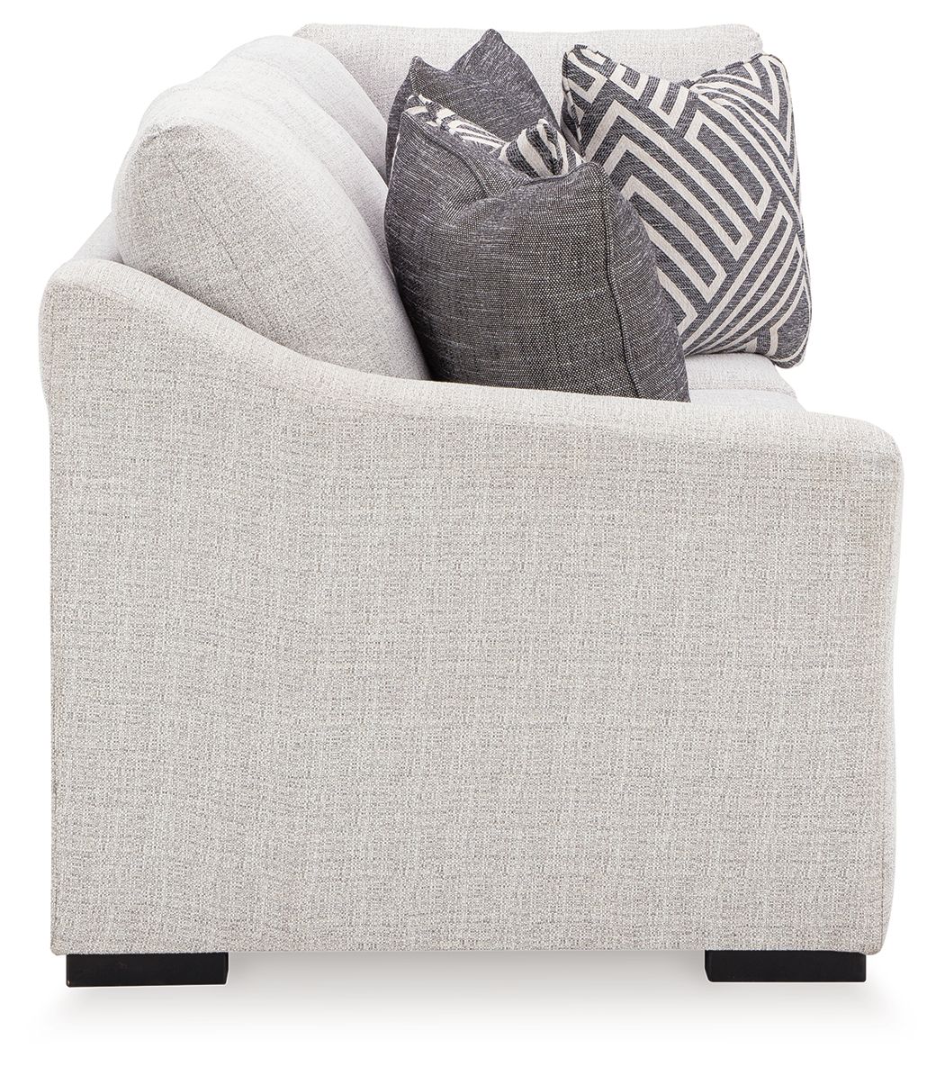 Stone beige sofa with corner wedge and dark patterned throw pillows